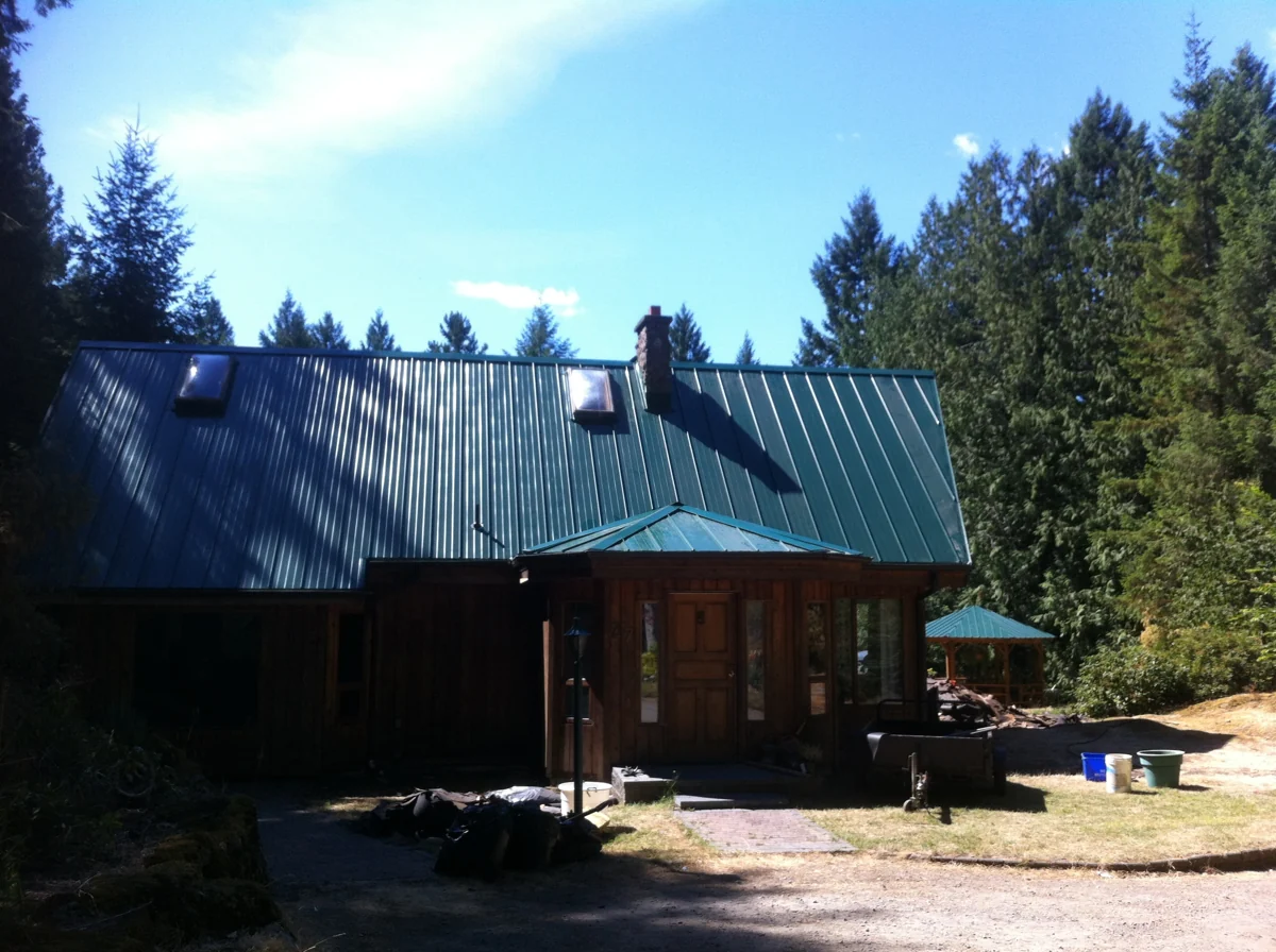 Timber house with a green metal roof