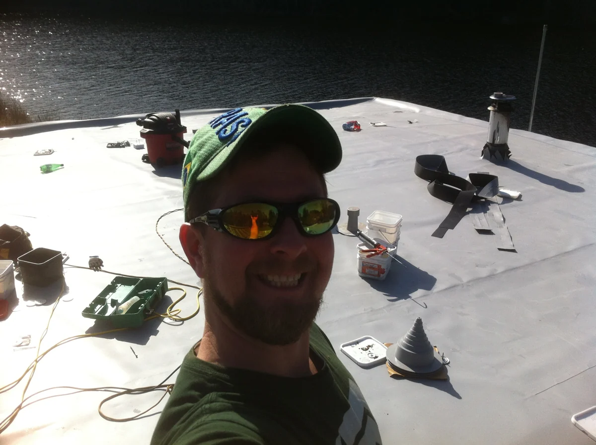 A roofer photographed at work on a flat roof