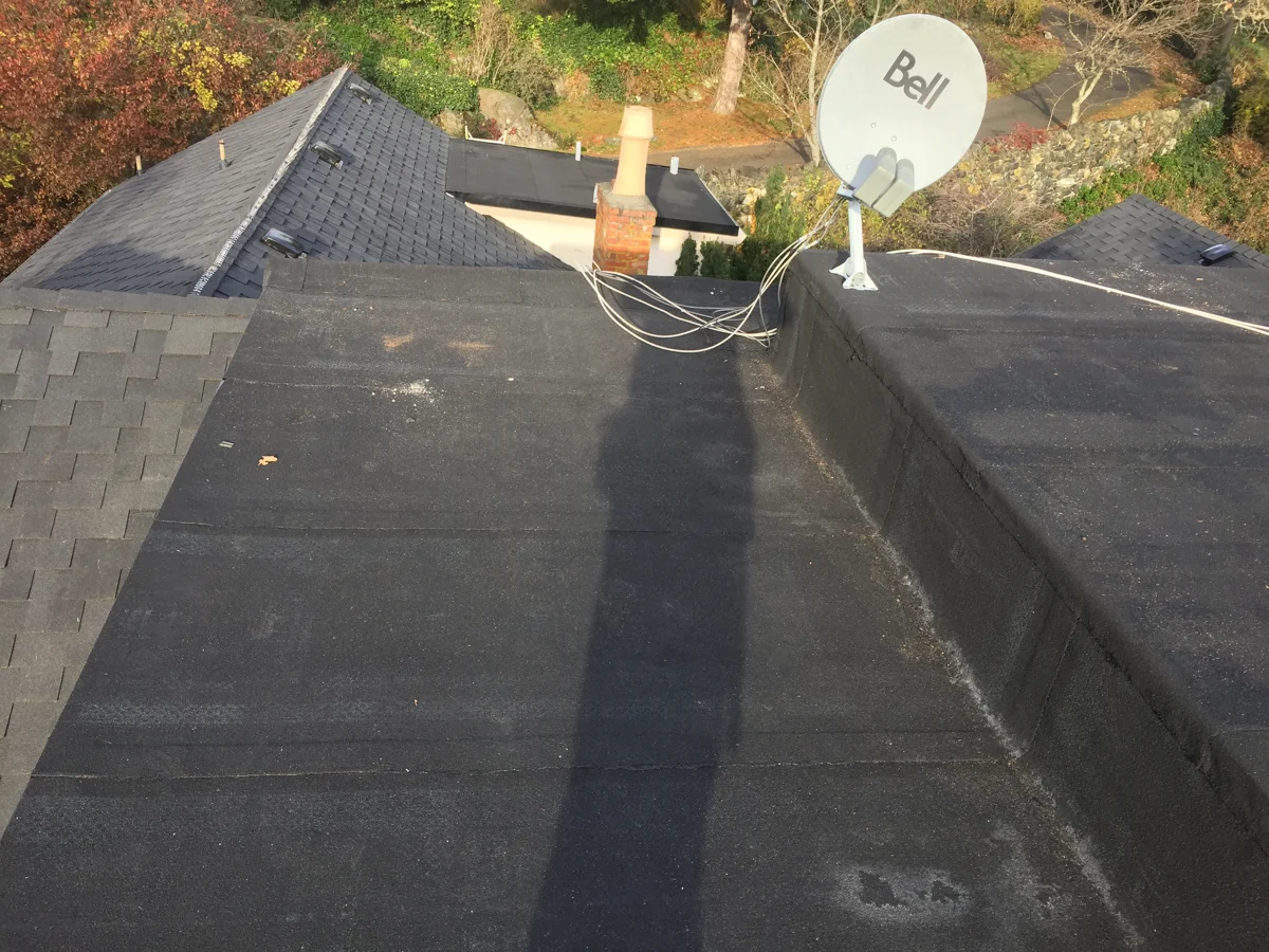Roofing and flashing details along a roof junction.
