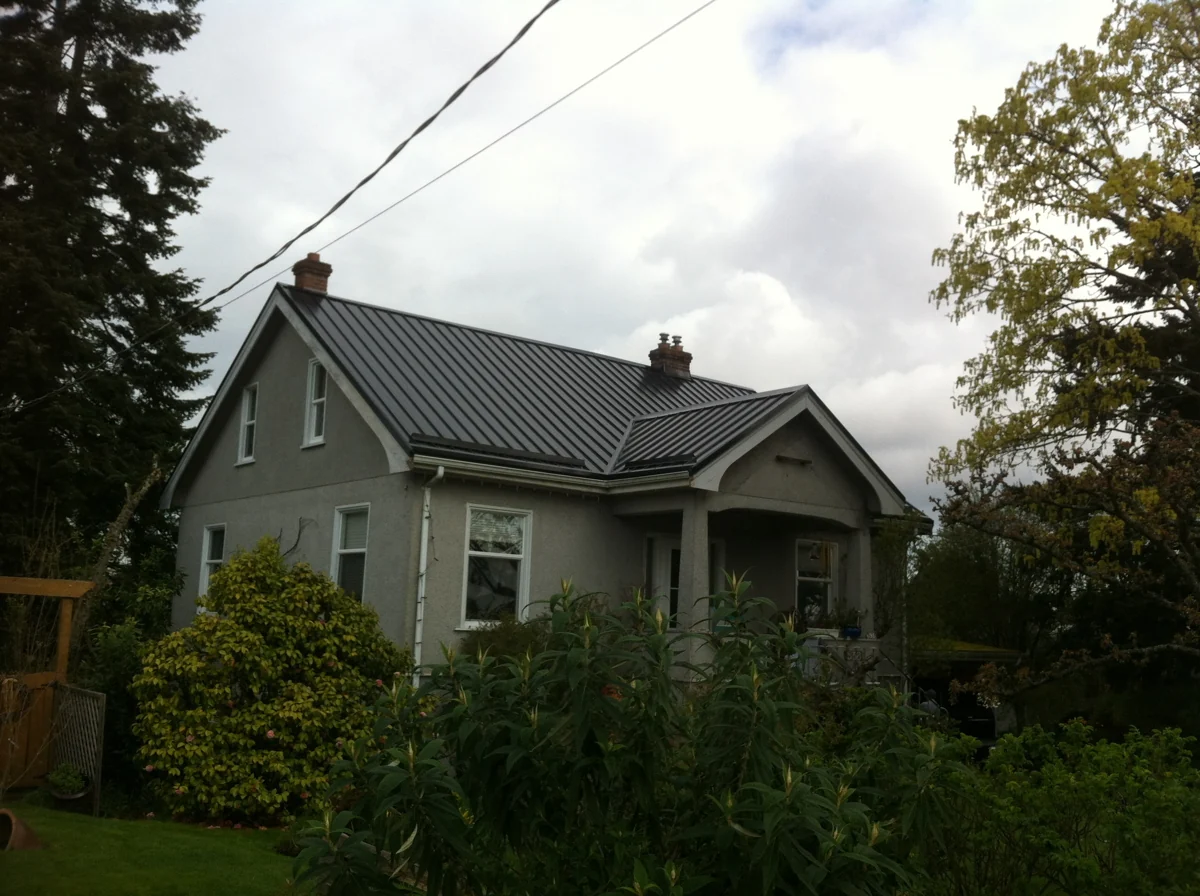 Square Deal gallery photograph of a green house with metal roofing